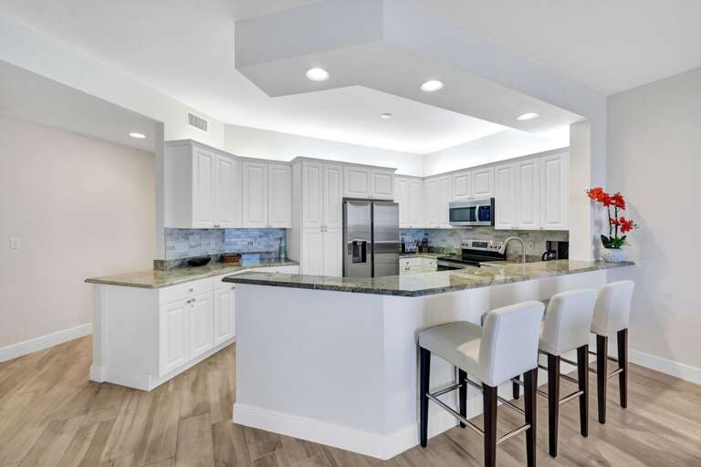 Residential Kitchen Interior With Island And Chairs