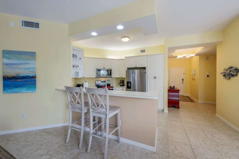 Residential Kitchen With Bar Stools And Dining Area Residential Kitchen With Bar Stools And Dining Area