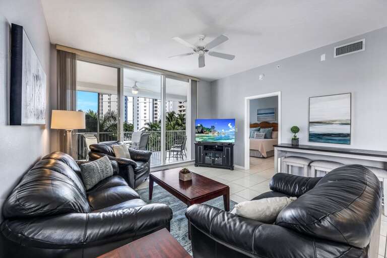 Interior Living Room With Black Leather Sofas And Television
