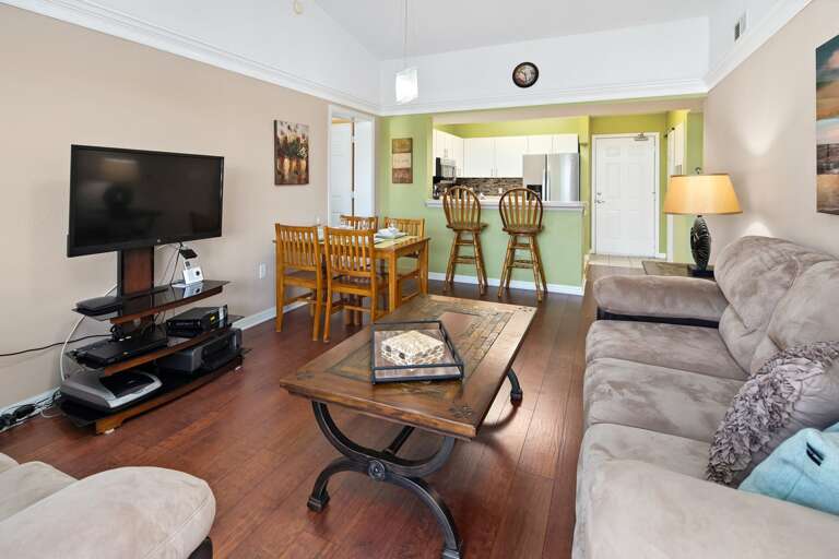 Living Room With Sectional Sofa, TV, And Dining Area In Background Living Room With Sectional Sofa, TV, And Dining Area In Background