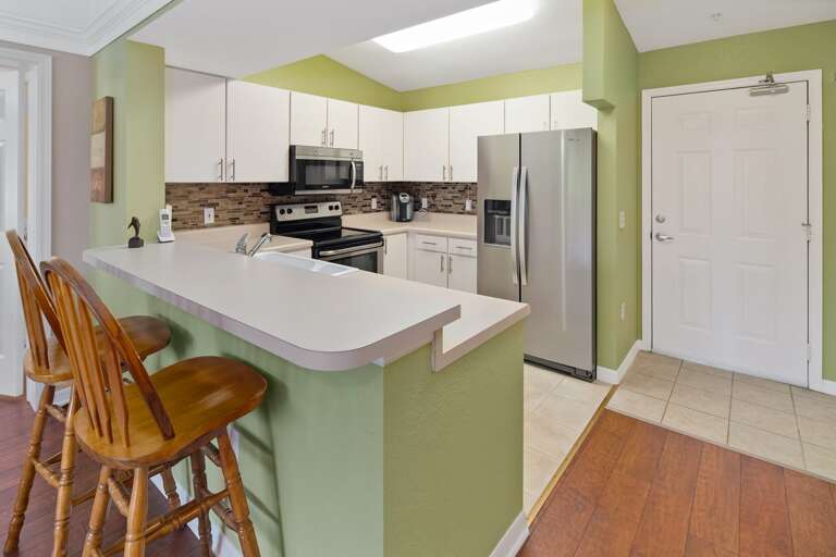 Kitchen Interior With Bar Stools And Appliances Kitchen Interior With Bar Stools And Appliances