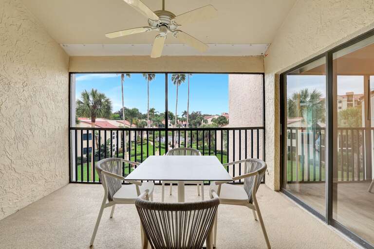 Screened Space Showcasing A Table Surrounded By Tropical Trees View