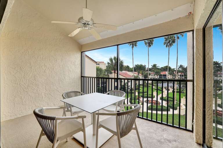 Palm-framed Patio View At A Vacation Rental
