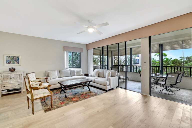 Bright, Breezy Living Space With Sliding Glass Doors And Light Flooring