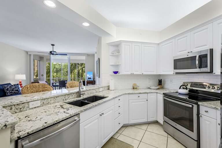 Kitchen Interior With White Cabinets And Stainless Steel Appliances