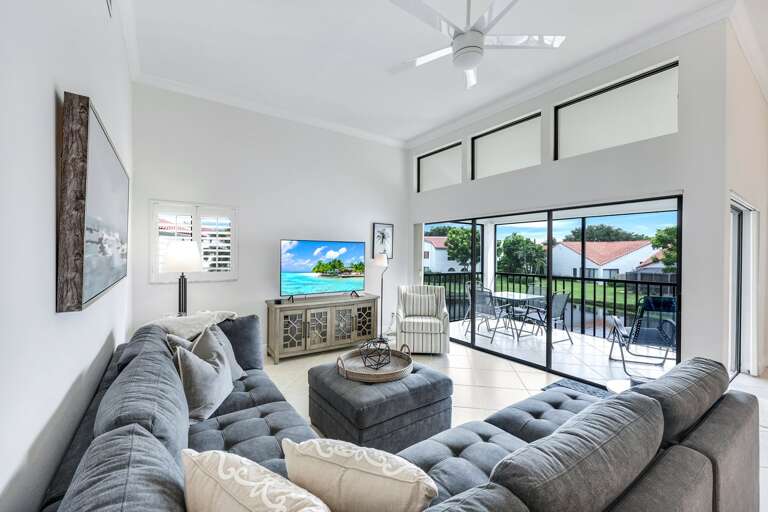 Bright Living Room With Sofa And TV Leading To Balcony Bright Living Room With Sofa And TV Leading To Balcony