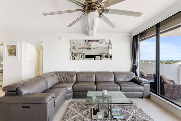 Bright Living Room With Large Sectional Sofa And Ceiling Fan Bright Living Room With Large Sectional Sofa And Ceiling Fan