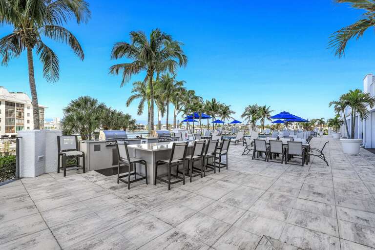 Palm Trees, Patio Tables, Blue Umbrellas, Clear Sky