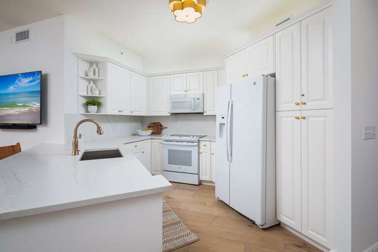 White-washed Kitchen Space Sporting Spotless Surfaces And Sleek Setup