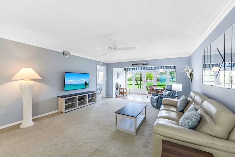 Bright, Breezy Living Space With Plush Seating And Sliding Glass Doors Bright, Breezy Living Space With Plush Seating And Sliding Glass Doors
