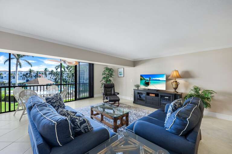 Spacious Living Room Leading To Lush Lanai In Scenic Setting, Vacation Rental View Visible Spacious Living Room Leading To Lush Lanai In Scenic Setting, Vacation Rental View Visible