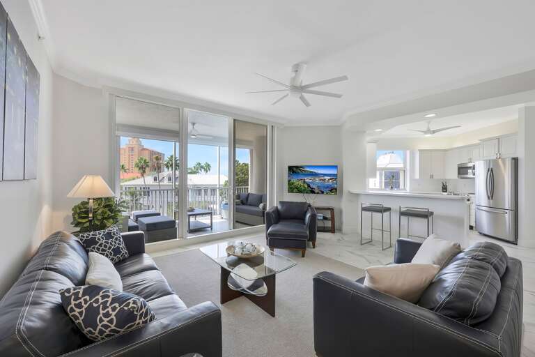 Spacious Living Space With Sleek Sofas And Scenic Balcony View