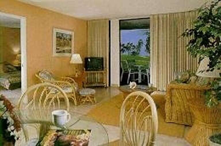 Interior View Of Tropical-themed Living Area With Balcony Access Interior View Of Tropical-themed Living Area With Balcony Access