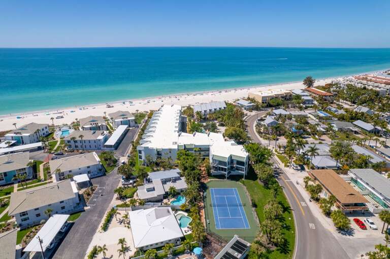 Coastal Complex With Tennis Court Near Sandy Seashore