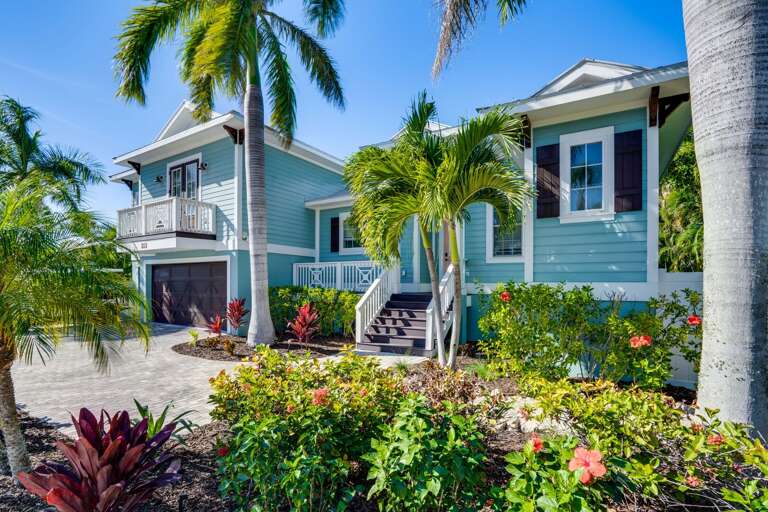 Blue Building, Vibrant Vegetation, Sunny Skies