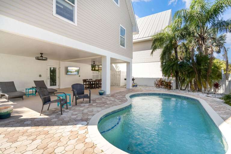 Poolside Patio With Palm Trees And Seating