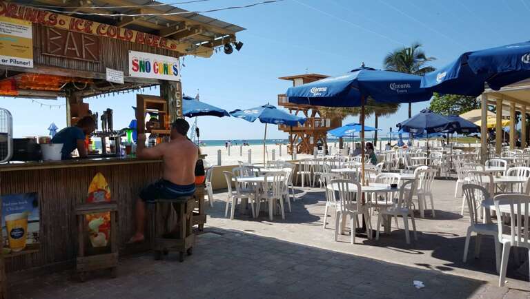 Stroll south to public beach cafe and Tiki with live music