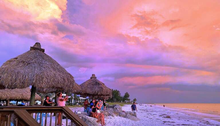Watch sunset at Beach Tikis