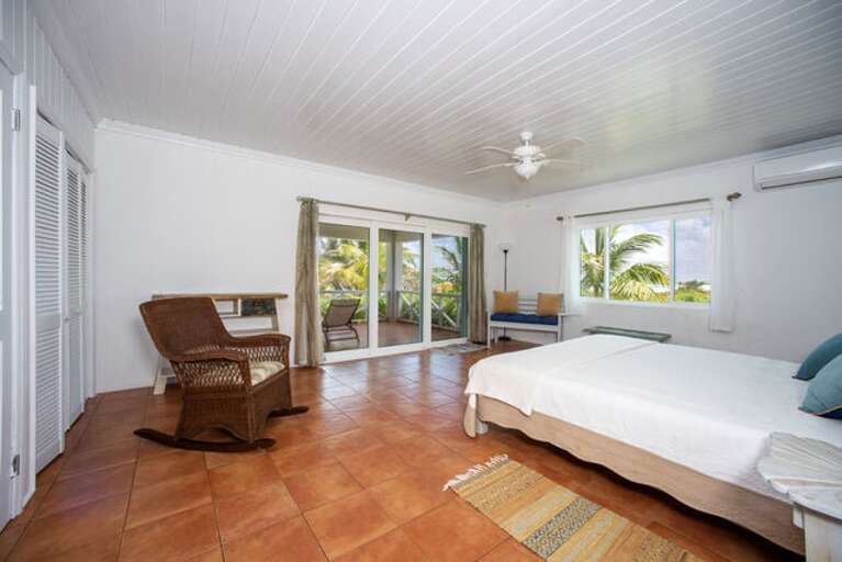 Master bedroom with ten-foot glass slider and spectacular ocean views