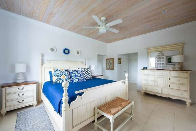 The master bedroom suite has an elegant ceiling of cypress boards and contains a king size bed. The master bedroom suite has an elegant ceiling of cypress boards and contains a king size bed.