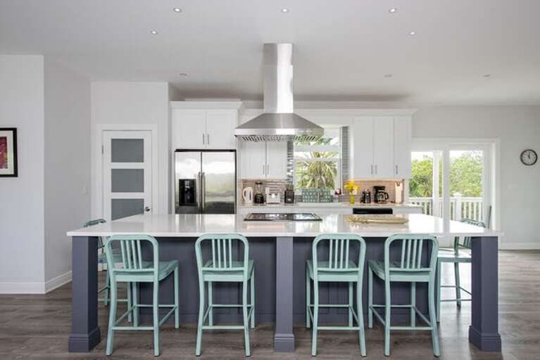 The 11' quartz island, with built in oven and range with overhead ventilation, seats six comfortably.