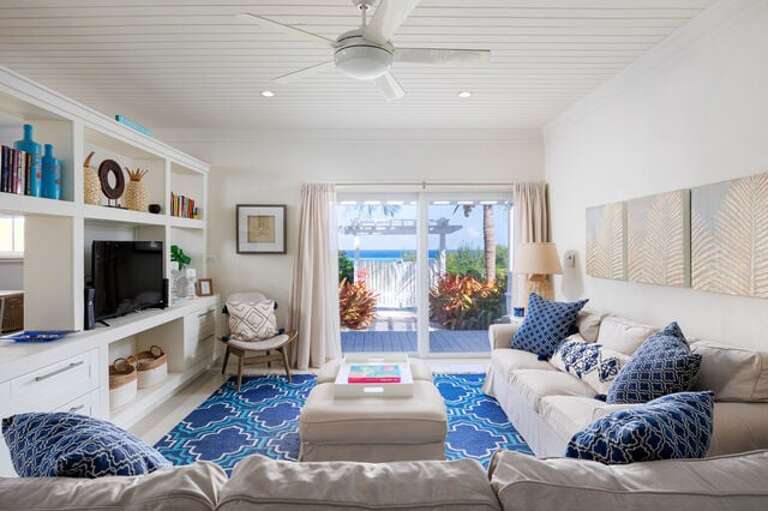 The elegantly decorated great room with stunning 24-inch tile floors has lounge seating for 6 and features a flat-screen satellite TV.