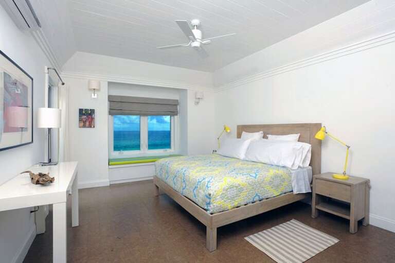Master suite with balcony and 50-mile Caribbean view, facing the sunset.