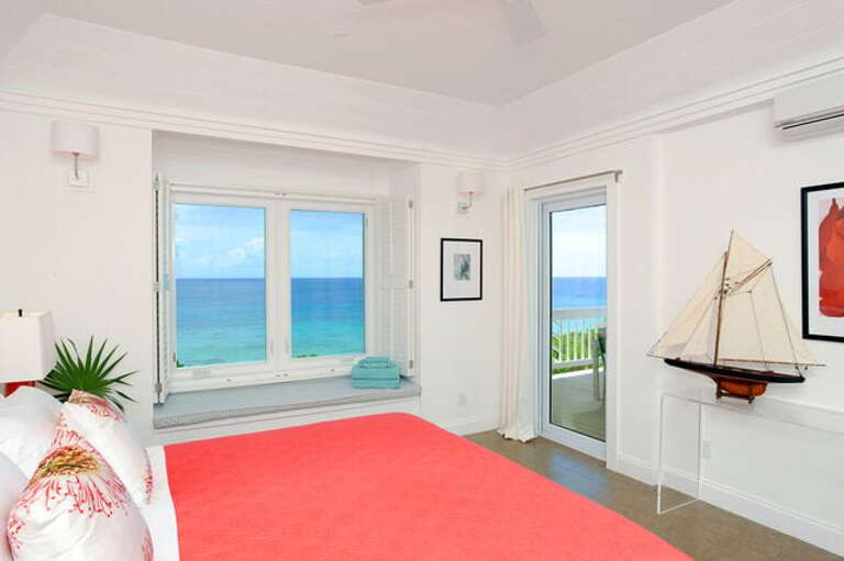 Master suite with balcony and 50-mile Caribbean view, facing the sunset.