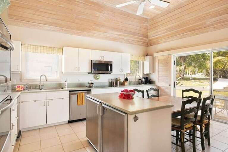 Modern chef's kitchen finished in quartz and stainless steel and fully equipped, including two wall ovens, wine cooler, and two refrigerators.