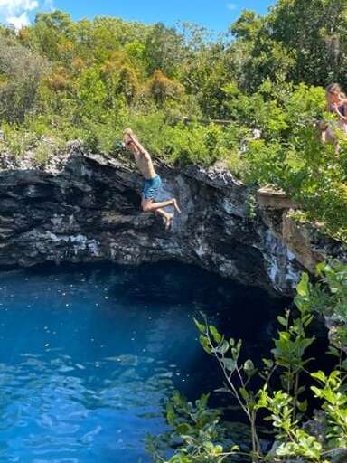 Cliff jumping at the Rock Sound Ocean Hole