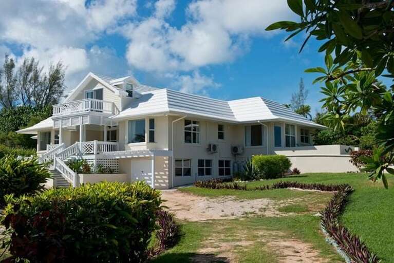 Driftwood house east facade at left, studio apartment porch at right.