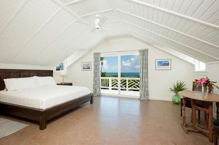 Master bedroom suite with king bed and ocean view.