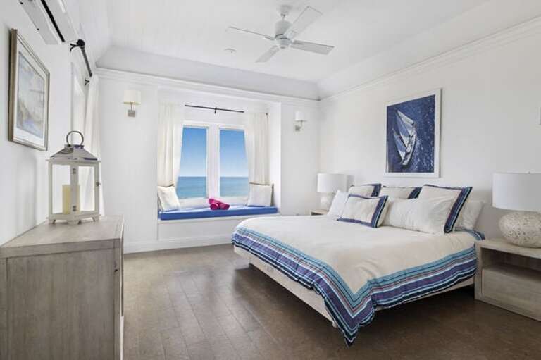 Master suite with balcony and 50-mile Caribbean view, facing the sunset.