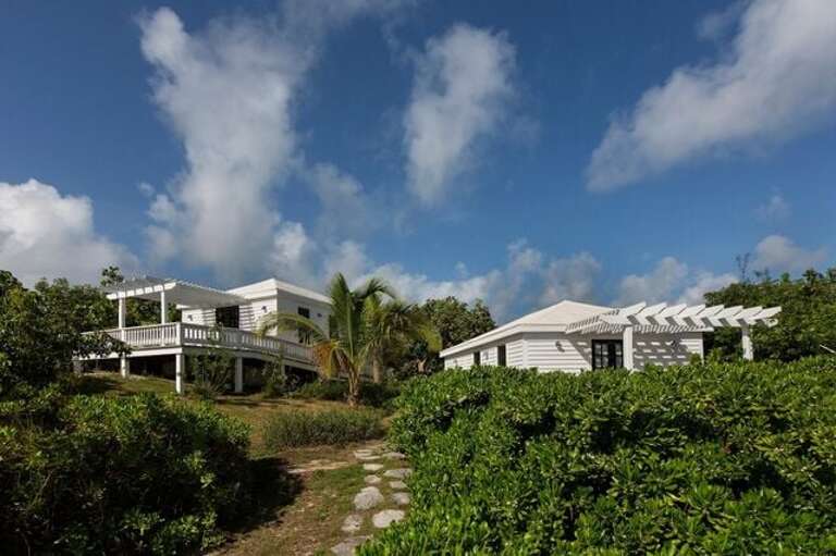 The two beach cottages with pool and ocean views.