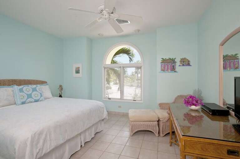 Bedroom 4 with king bed, garden view, and en suite bath Bedroom 4 with king bed, garden view, and en suite bath