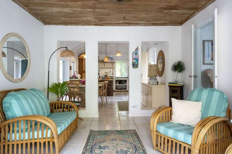 Living Area with a beautiful wooden tray ceiling and comfortable furniture.