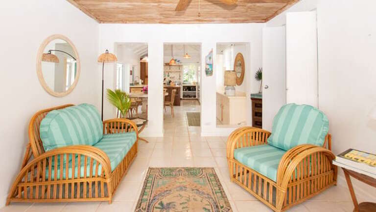 Living Area with a beautiful wooden tray ceiling and comfortable furniture.