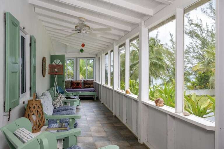 Screened in porch with additional seating.