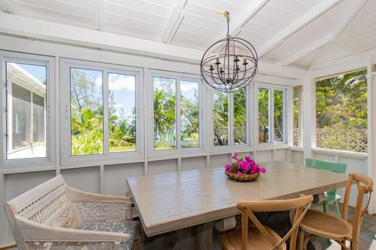The screened porch with dining table.