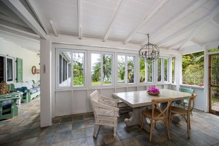 The screened porch with dining table.