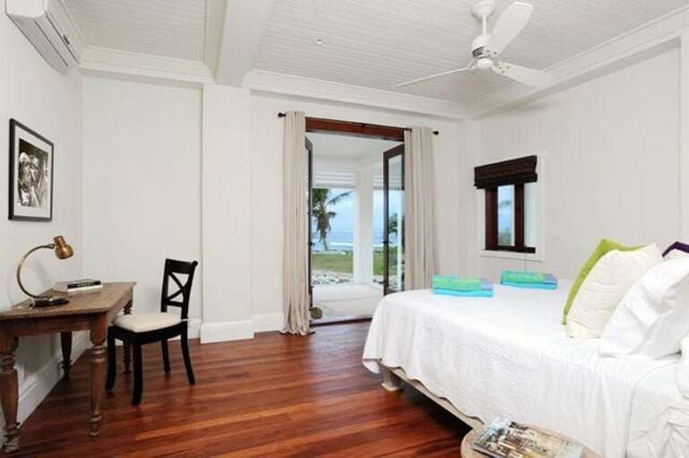 Downstairs master suite with king bed, en suite full bath, and ocean views.