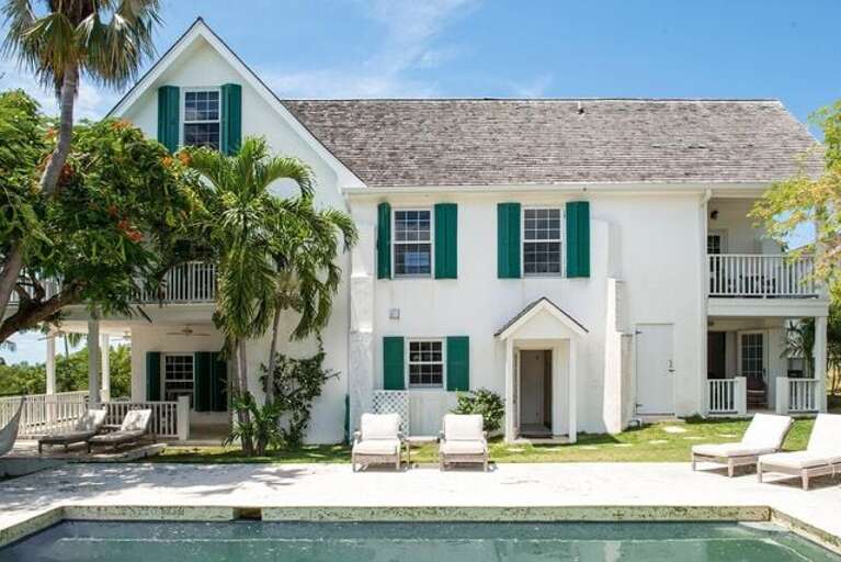 Back yard and pool. Plenty of lounge chairs, plus more under the pool cabana.