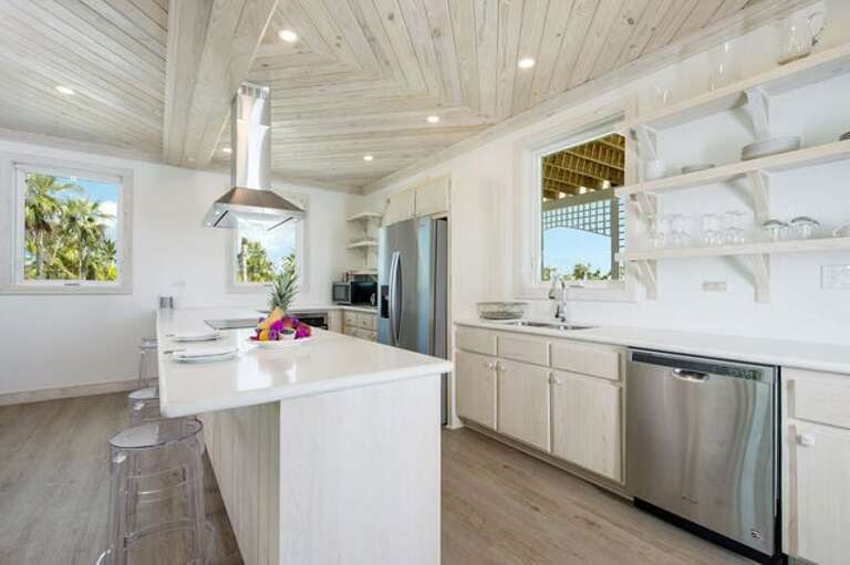 Fully equipped kitchen features stainless steel appliances and a quartz counter top