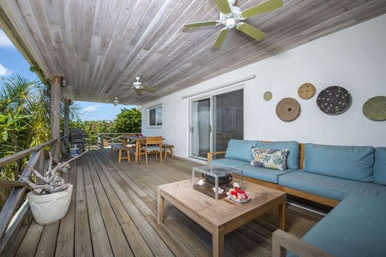 Covered porch with lounging and outdoor dining