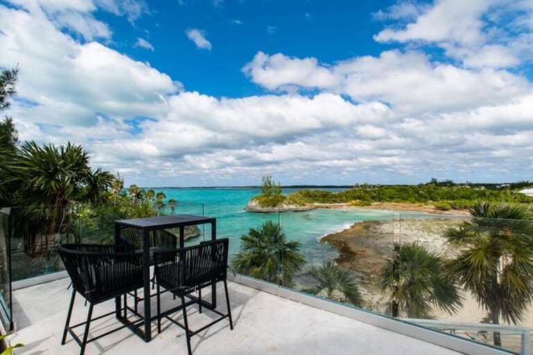 Ocean-view deck areas with sweeping ocean views, furnished for lounging and dining.