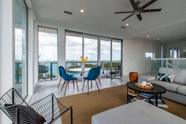 This room is furnished for both lounging and dining and has an adjacent kitchen.