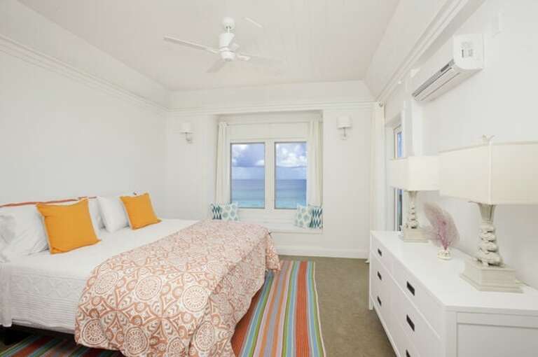 Master suite with balcony and 50-mile Caribbean view, facing the sunset.