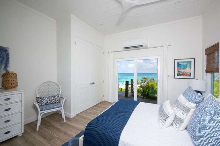 Bedroom suite three with ocean view, en-suite bath, and queen bed.