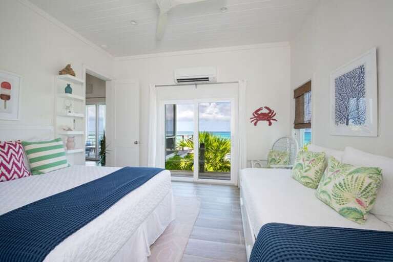 Bedroom suite two with ocean view, en-suite bath, queen bed, and single bed with trundle.
