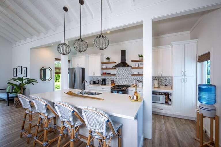 Our fully equipped open-concept kitchen with 6-gas burner and 9-foot quartz island with seating.